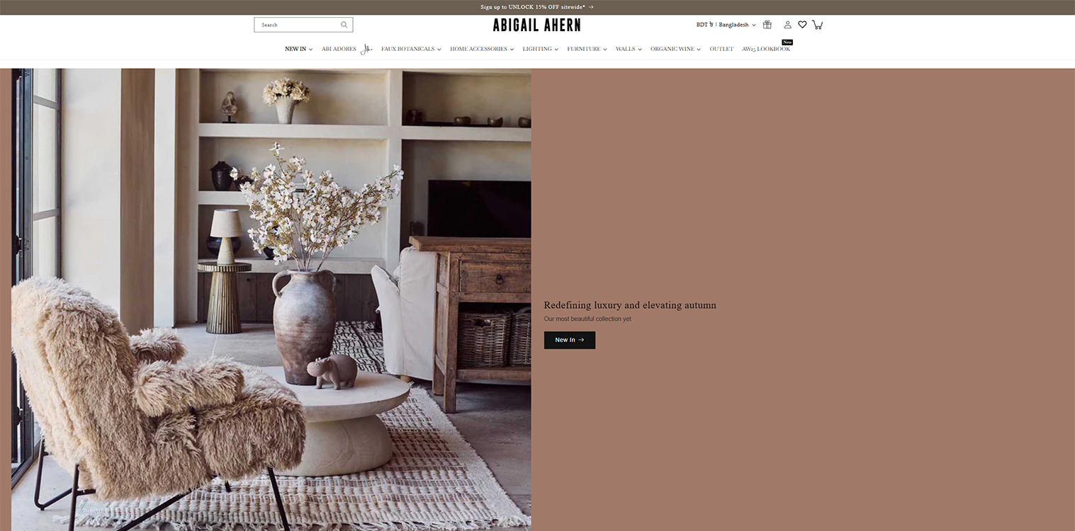 Cozy living room featuring a plush, fur-covered armchair, a round coffee table, and a decorative vase filled with flowers. The space exudes warmth with natural light, wooden furniture, and a minimalist design aesthetic.