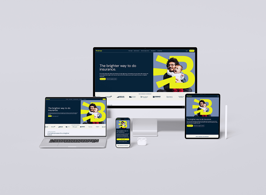 Mockup of a responsive insurance website displayed on multiple devices, including a desktop computer, laptop, tablet, and smartphone. The homepage features a modern design with the tagline 