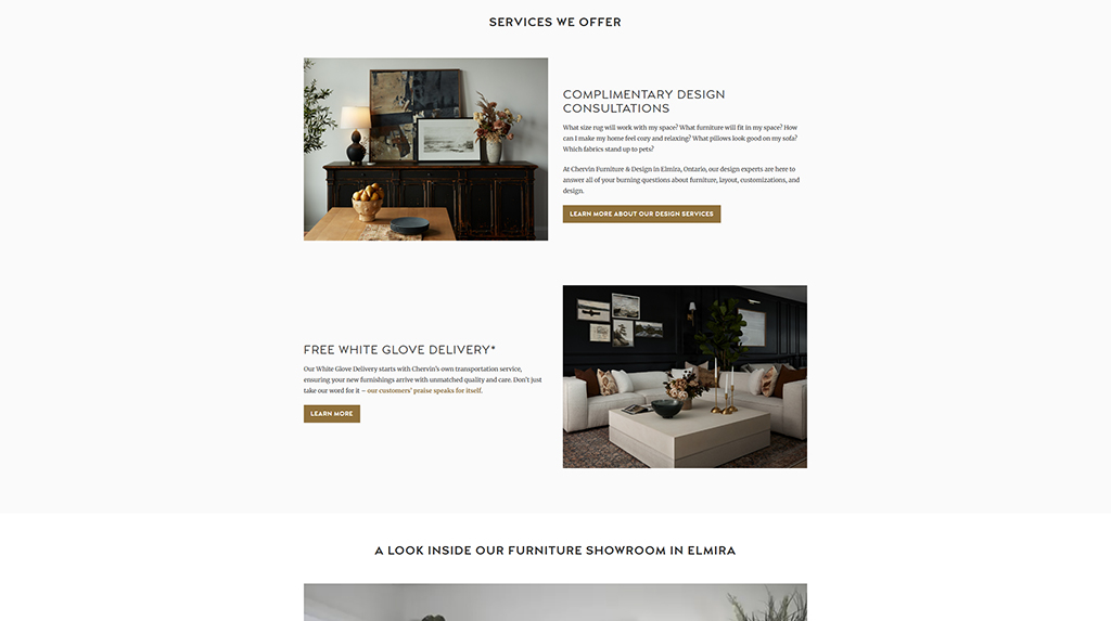 Image of a stylish furniture showroom featuring a modern living room setup with a light-colored coffee table, plush sofa, decorative plants, and artwork on the walls. The layout showcases design consultation services and free white glove delivery offered by a furniture store in Elmira.