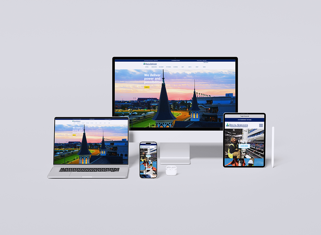 Image showcasing a responsive website design for Delta Services displayed on multiple devices, including a desktop monitor, laptop, smartphone, and tablet. The website features a visually appealing sunset background and highlights the company's commitment to delivering power and possibilities.