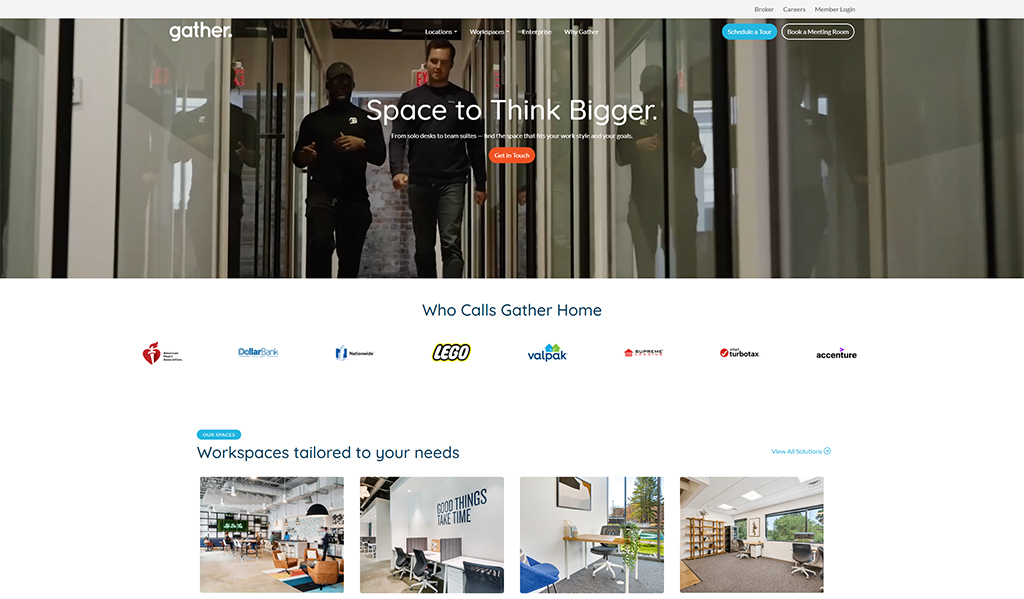 Image of a modern workspace featuring two professionals walking through a glass corridor, showcasing the collaborative environment at Gather. The homepage highlights the tagline 