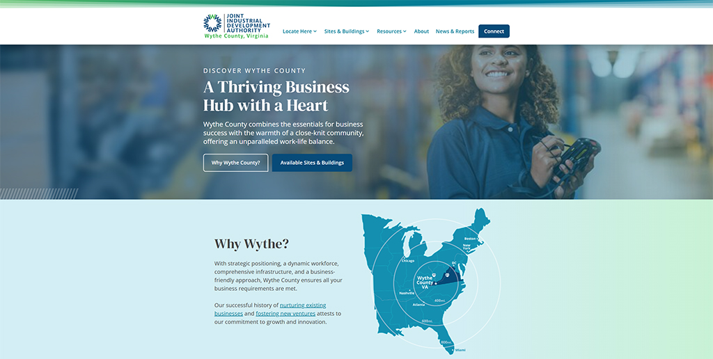 Woman smiling while using a handheld device in a modern business environment, promoting Wythe County, Virginia as a thriving business hub with a focus on community, work-life balance, and economic growth.