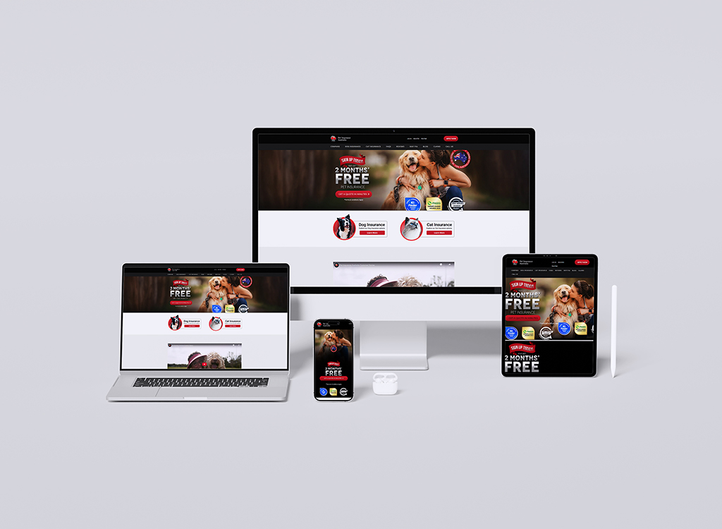 A variety of devices displaying a pet insurance website, featuring a promotional offer of two months free, with images of dogs and cats, highlighting services for pet owners.
