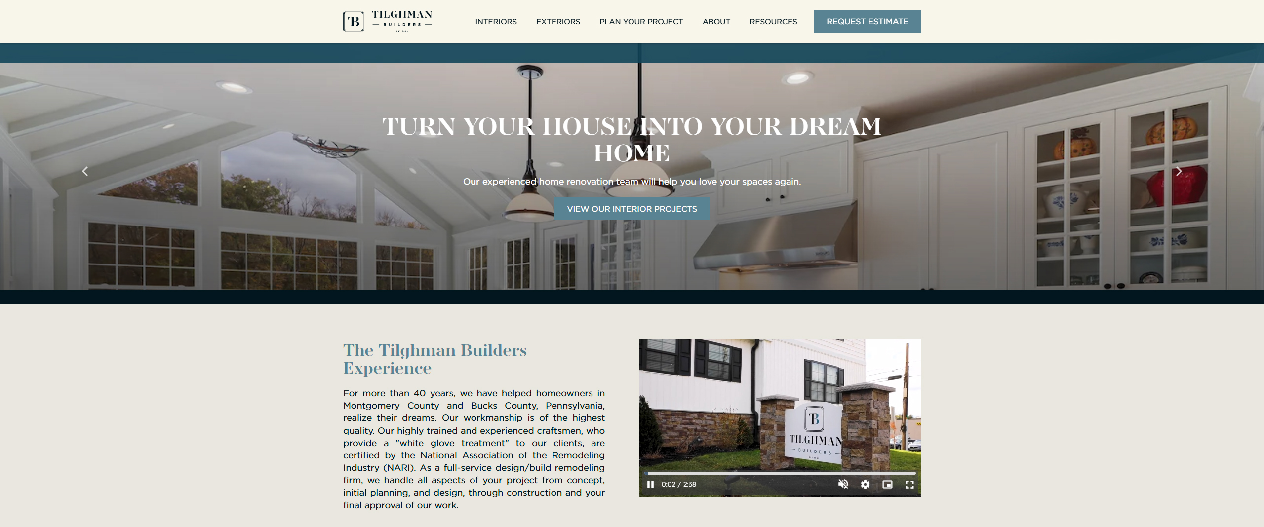 Interior design and renovation website for Tilghman Builders, showcasing a bright, modern kitchen with large windows, white cabinetry, and stylish lighting fixtures. The image highlights the company's focus on transforming homes in Montgomery and Bucks County, Pennsylvania.