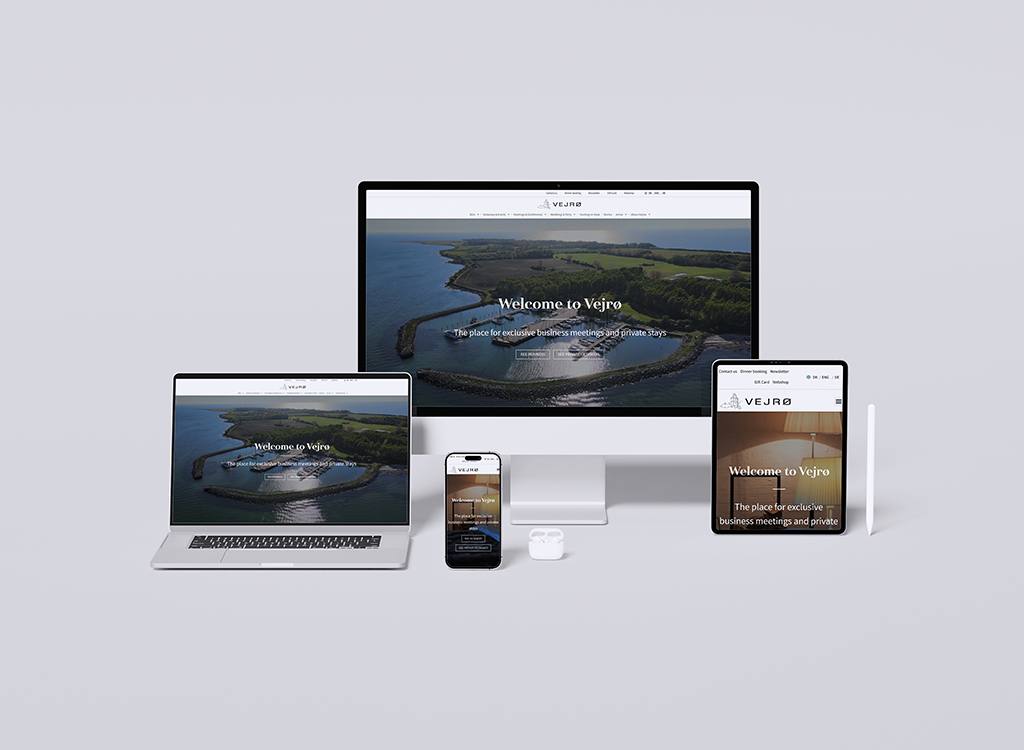 Image showcasing multiple devices (desktop, laptop, tablet, and smartphone) displaying the Vejrø website, featuring a welcoming message about exclusive business meetings and private stays in a scenic coastal setting.