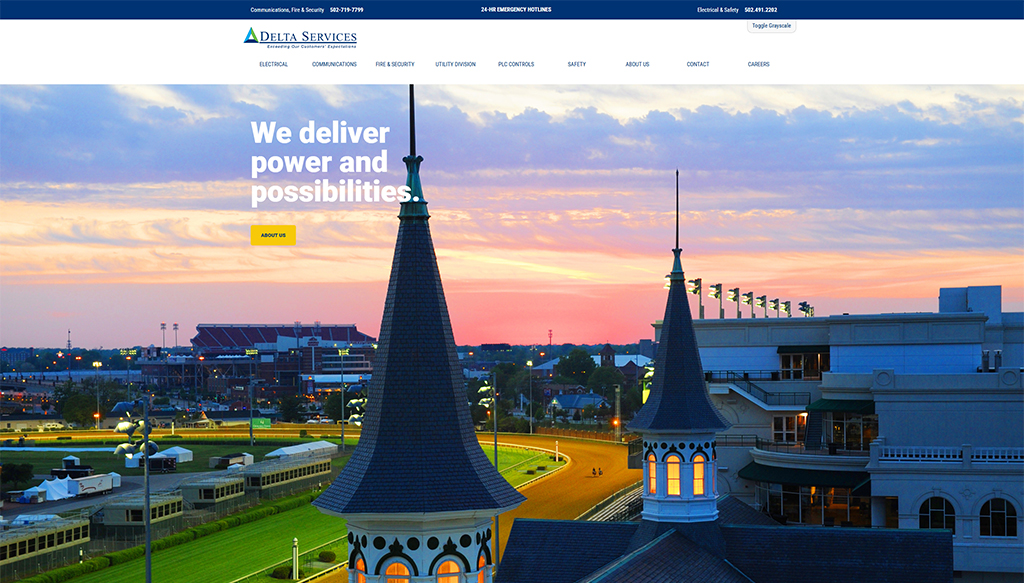 Aerial view of Delta Services headquarters with a focus on the iconic spire at sunset, showcasing the company's commitment to delivering electrical, communications, and safety solutions.