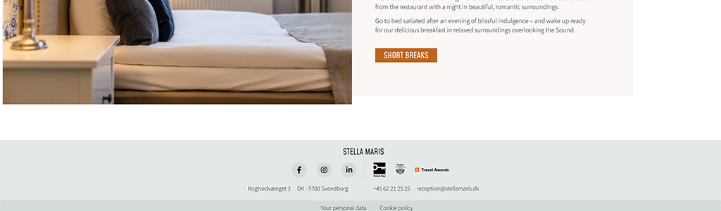 Cozy bedroom with a neatly made bed and decorative pillows, ideal for a romantic getaway at Stella Maris in Svendborg, Denmark. The image highlights the inviting atmosphere perfect for relaxation and comfort.