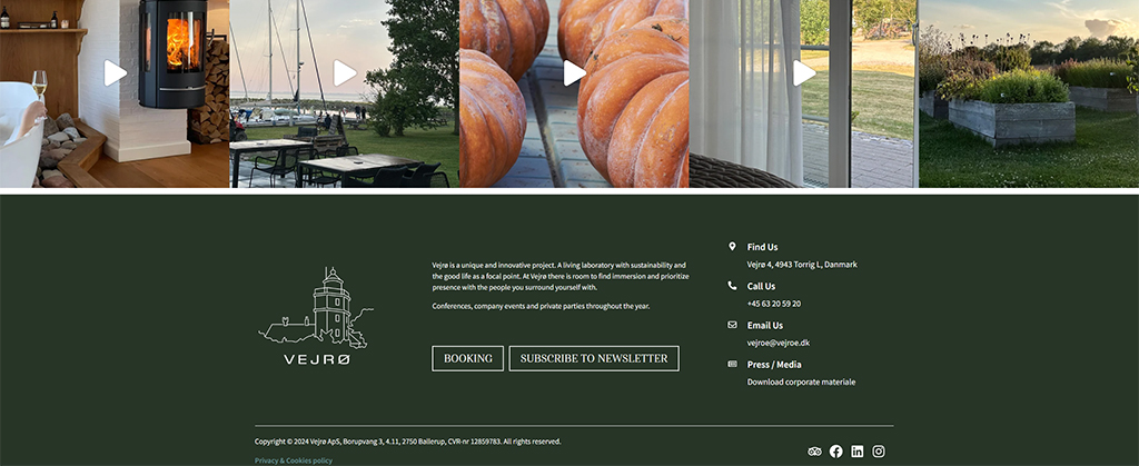 Image of Vejrø, a unique project in Denmark, showcasing a cozy interior with a fireplace, scenic outdoor views, and freshly baked pastries. The site promotes sustainability and offers spaces for conferences and private events, emphasizing connection with nature and community.